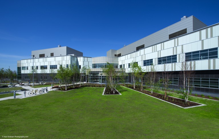 Grass and landscape outside of large multistory building