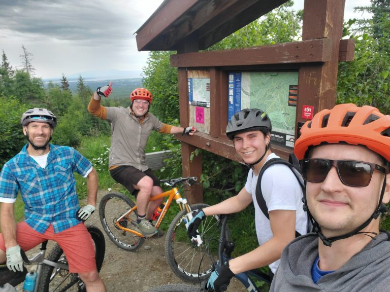 Four men biking on a mountain trail