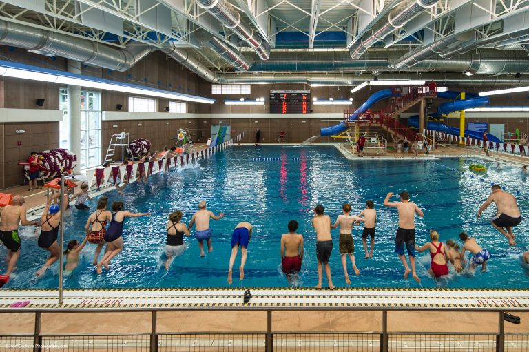 People jumping into pool