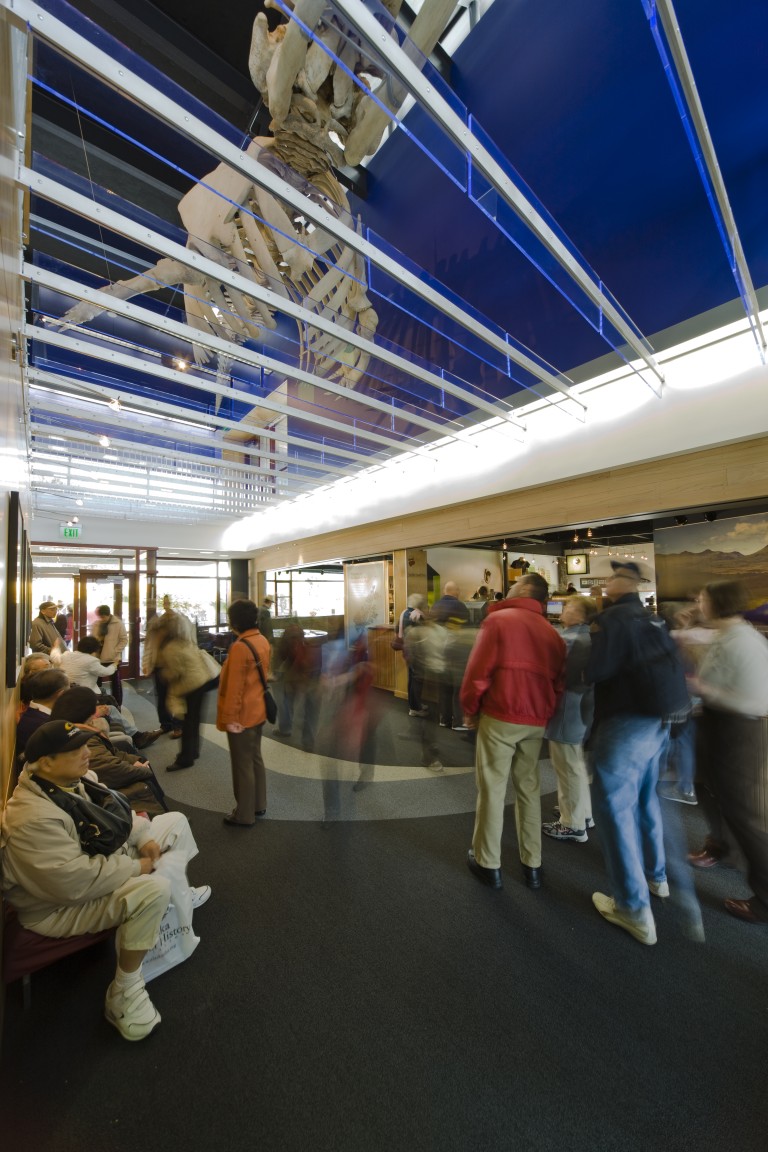 Large group of people in entryway of brightly lit room