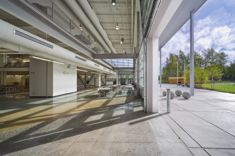 Lighting and vents in cafeteria with large open garage doors
