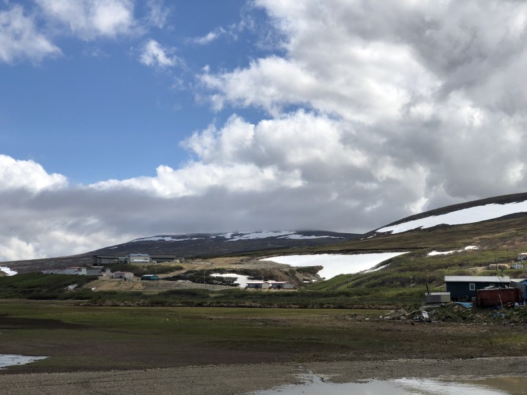 Buildings scattered in distance across snowy mountains